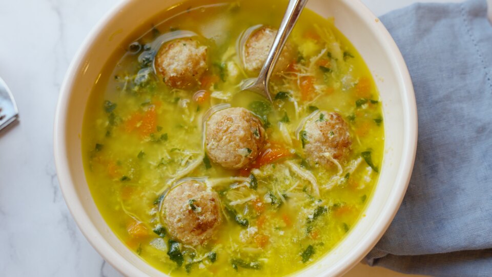 Italian wedding soup with chicken meatballs, vegetables and herbs